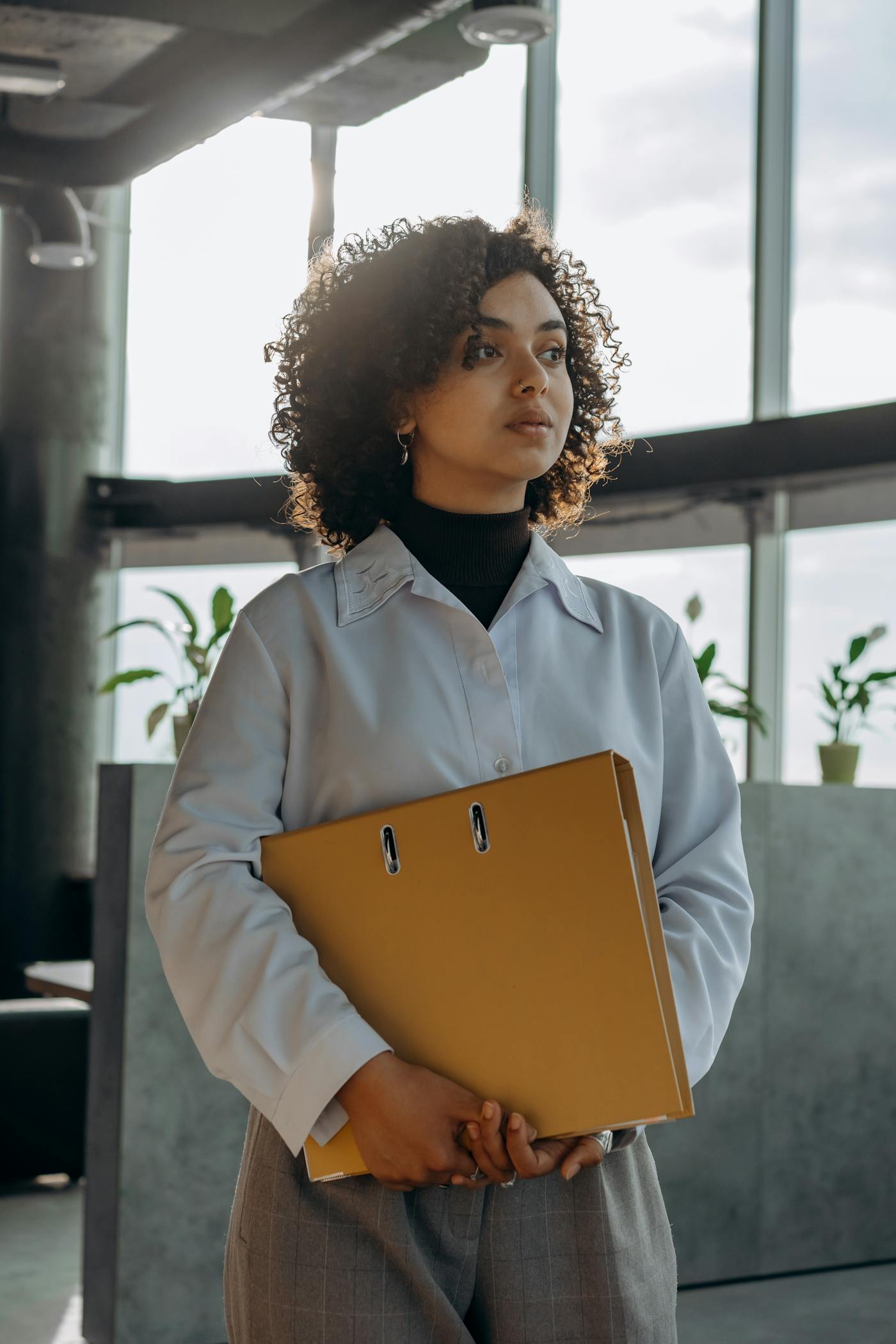 Investment professional holding governance materials in a quiet office