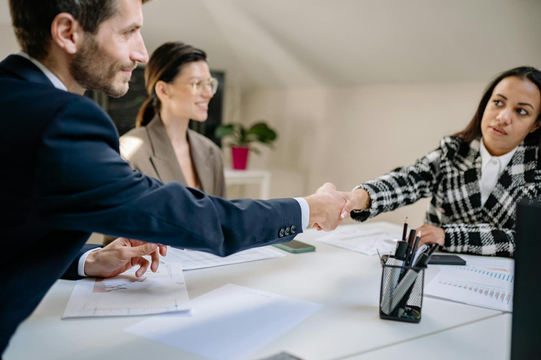 Financial advisor greeting a client during a private capital meeting