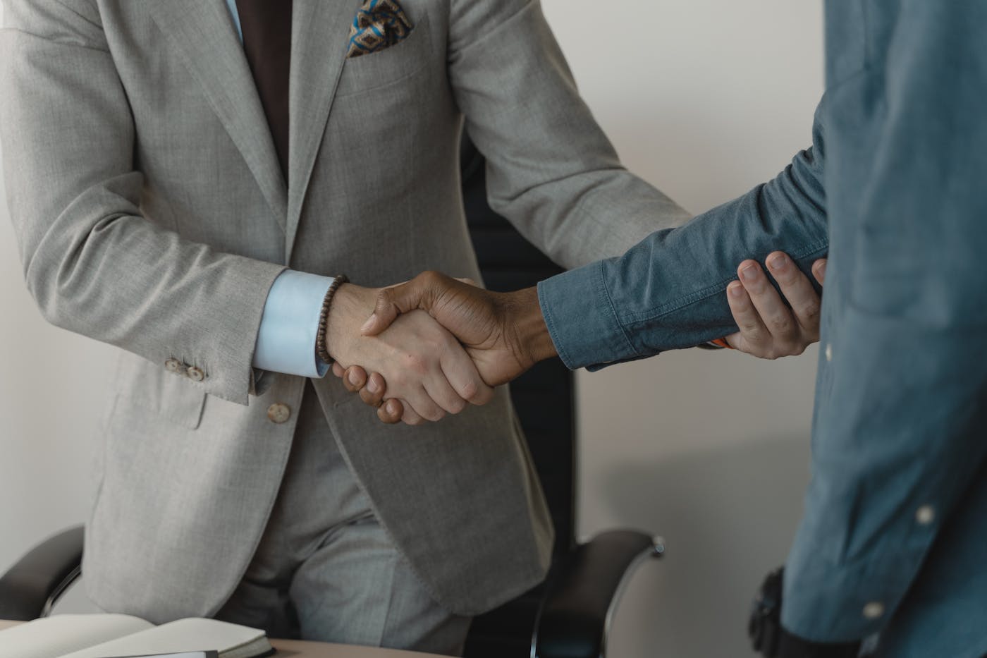 Private capital handshake during a family office meeting