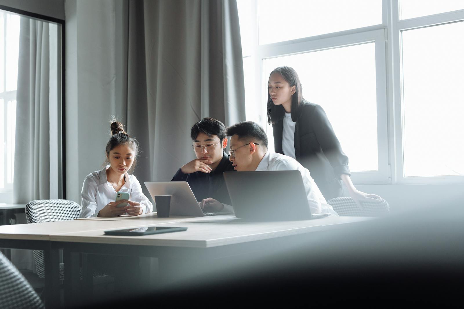 Professionals collaborating in a bright office workspace