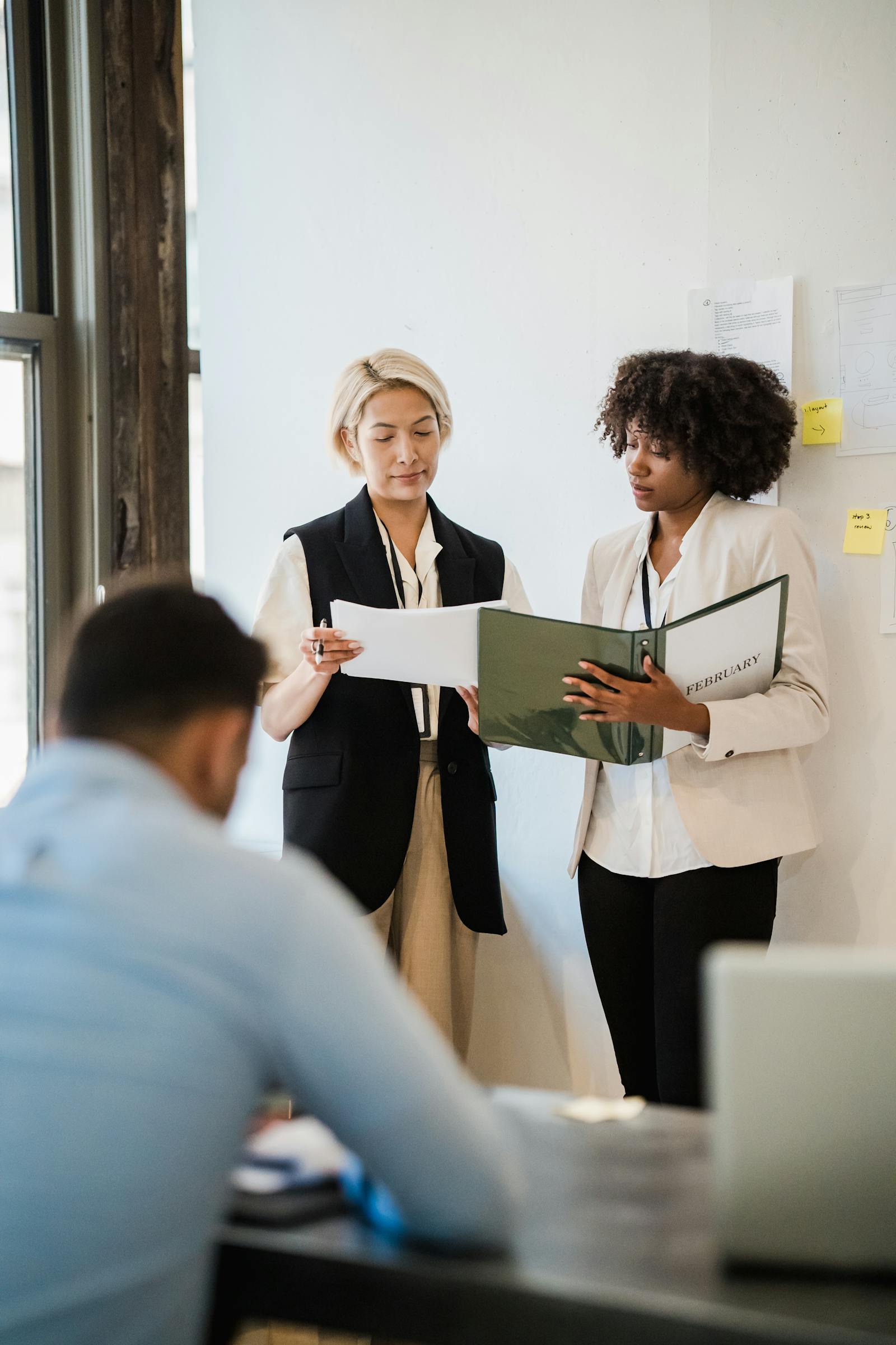 Advisory professionals reviewing client documents in a private meeting