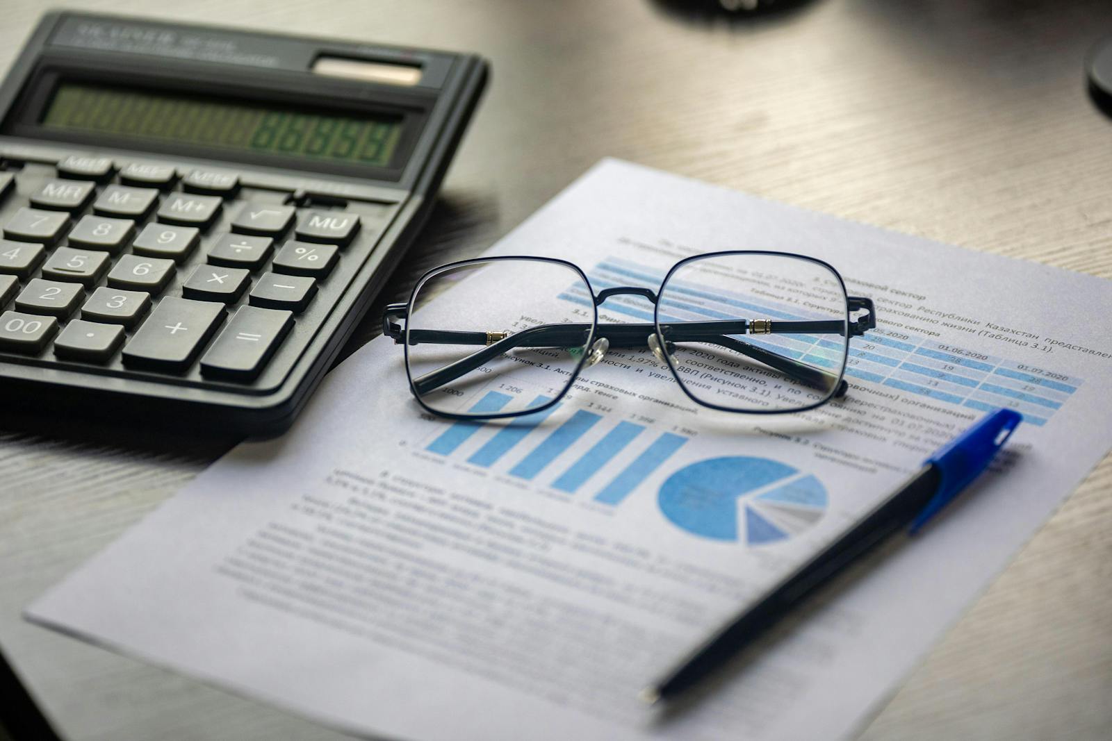 Financial report, calculator, and analytical documents arranged for strategy review